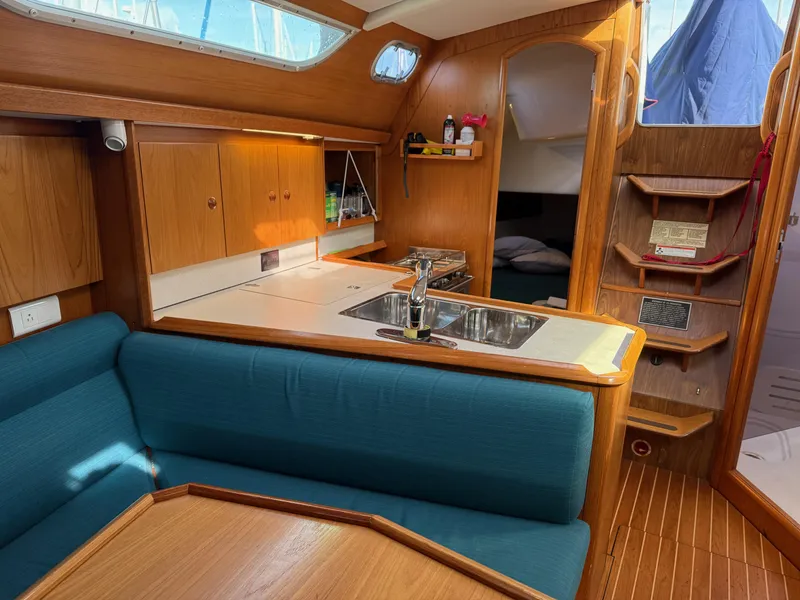 Slide: The Image of Interior of 1999 Jeanneau Sun Odyssey 36.2 sailboat with kitchen and seating area. - 12