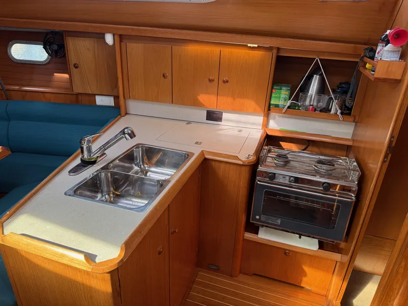 Slide: The Image of Interior of 1999 Jeanneau Sun Odyssey 36.2 yacht kitchen with sink and stove. - 14
