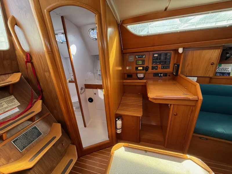 Slide: The Image of Interior of 1999 Jeanneau Sun Odyssey 36.2 sailboat with wooden cabinetry and navigation station. - 15