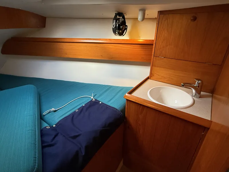 Slide: The Image of Cozy cabin interior of 1999 Jeanneau Sun Odyssey 36.2 with sink and wooden cabinetry. - 16