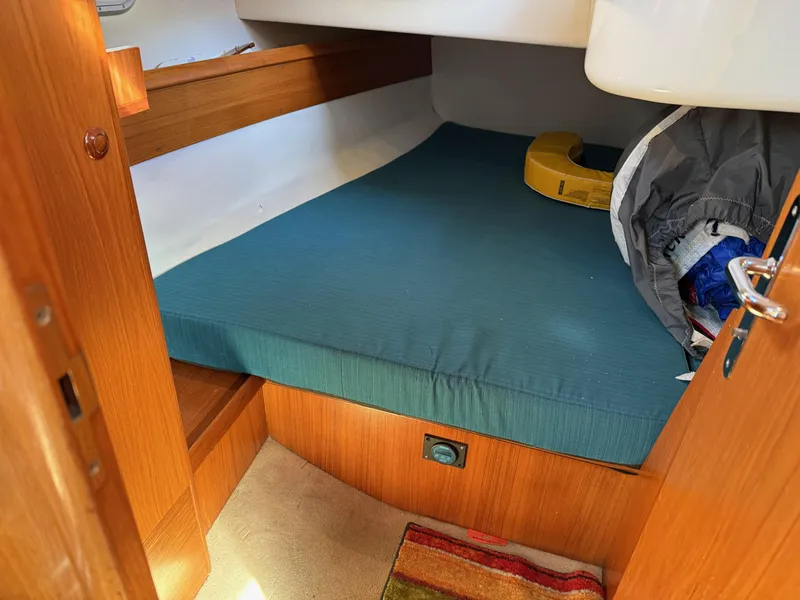 Slide: The Image of Cozy cabin interior of 1999 Jeanneau Sun Odyssey 36.2 sailboat with teal bedding. - 20