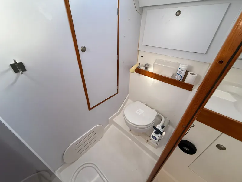 Slide: The Image of Bathroom interior of 1999 Jeanneau Sun Odyssey 36.2 yacht, featuring toilet and storage. - 23