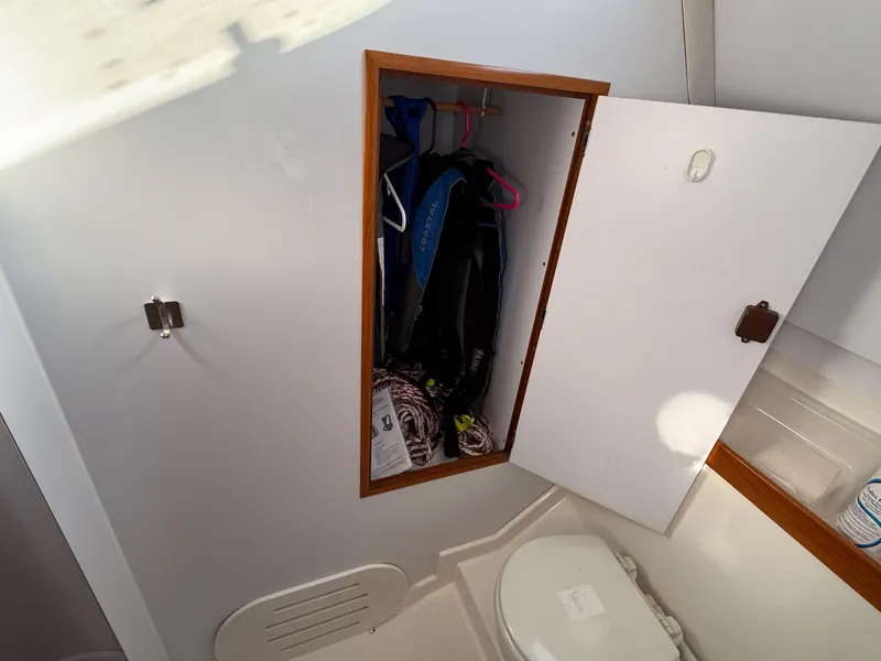 Slide: The Image of Interior of 1999 Jeanneau Sun Odyssey 36.2 showing bathroom storage and toilet. - 24