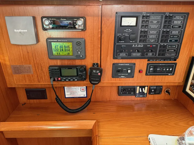 Slide: The Image of Control panel of a 1999 Jeanneau Sun Odyssey 36.2 sailboat with navigation and communication equipment. - 26