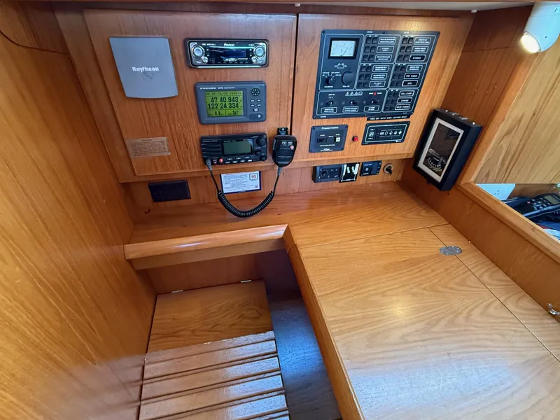 Slide: The Image of Navigation station of 1999 Jeanneau Sun Odyssey 36.2 with control panels and communication equipment. - 27