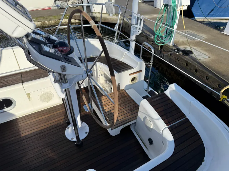 Slide: The Image of Cockpit of 1999 Jeanneau Sun Odyssey 36.2 sailboat with wooden steering wheel. - 3