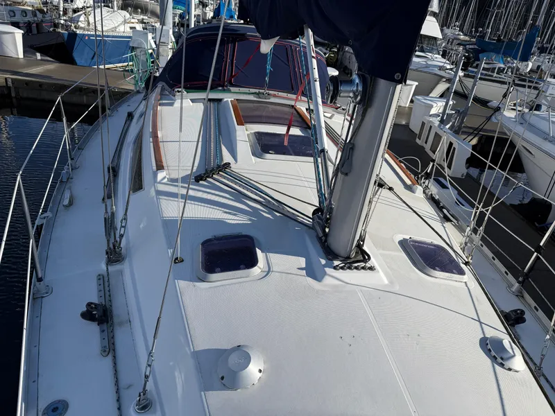 Slide: The Image of 1999 Jeanneau Sun Odyssey 36.2 sailboat docked at marina, view of deck and mast. - 33