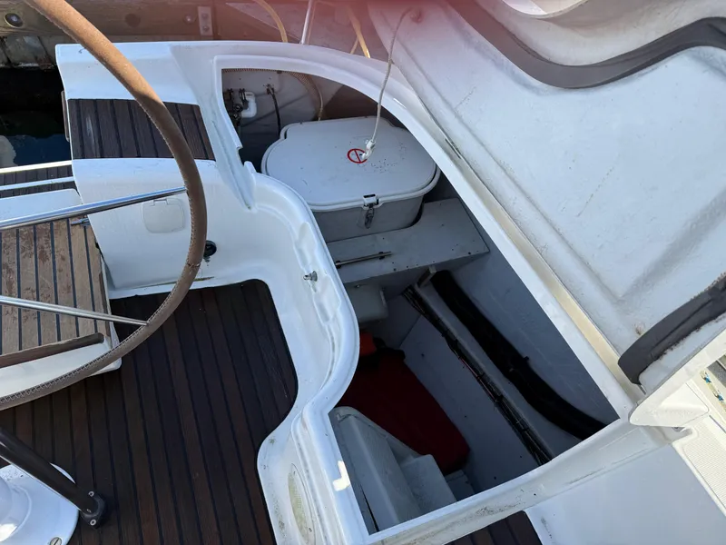 Slide: The Image of Cockpit view of 1999 Jeanneau Sun Odyssey 36.2 sailboat with open hatch and wooden flooring. - 35
