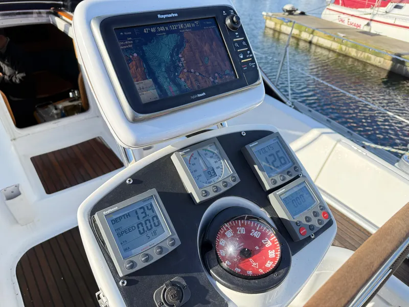 Slide: The Image of Cockpit of 1999 Jeanneau Sun Odyssey 36.2 with navigation instruments and GPS display. - 36
