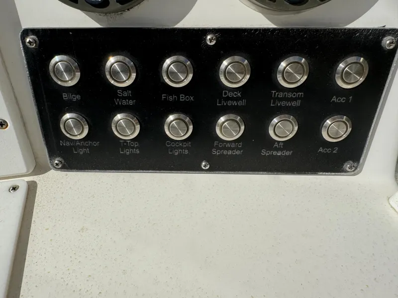 Slide: The Image of Control panel of a 2004 Regulator 26 FS boat with labeled switches. - 19