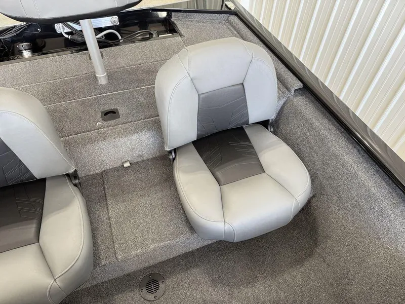 Slide: The Image of 2025 Tracker Pro 170 boat interior with gray seating and carpeted flooring. - 11