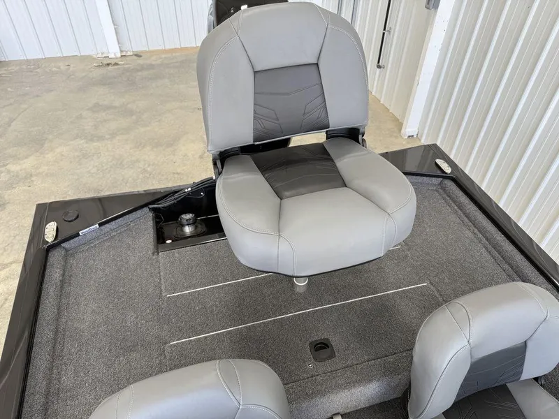 Slide: The Image of 2025 Tracker Pro 170 boat seat, gray upholstery, in a garage setting. - 14