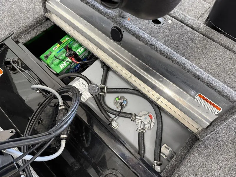Slide: The Image of 2025 Tracker Pro 170 boat interior showing battery and wiring components. - 16