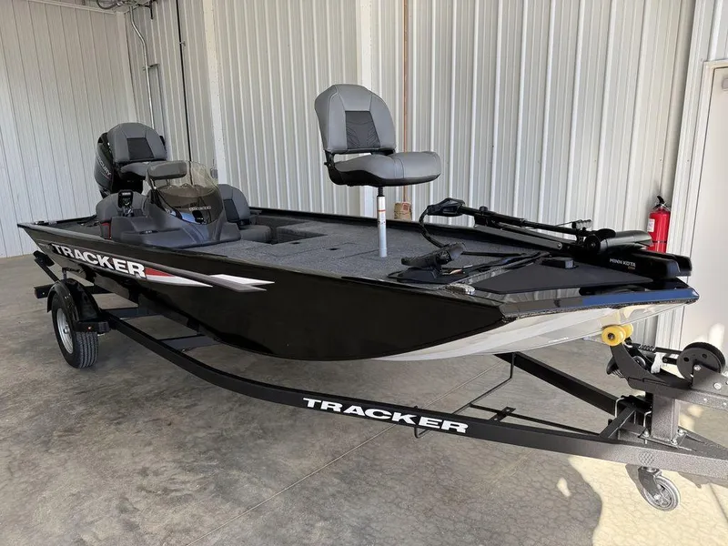 Slide: The Image of 2025 Tracker Pro 170 fishing boat in a garage, featuring sleek design and modern seating. - 3