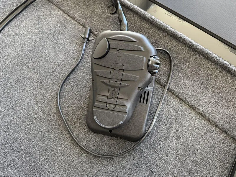 Slide: The Image of Foot pedal control on 2025 Tracker Pro 170 boat, resting on gray carpeted surface. - 5