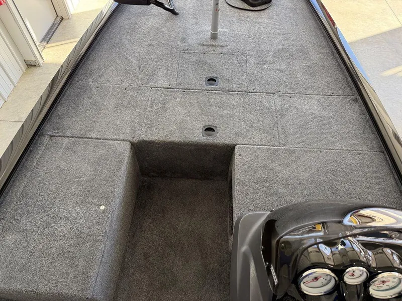 Slide: The Image of 2025 Tracker Pro 170 boat interior with gray carpet and control panel. - 6