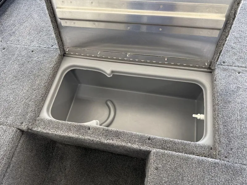 Slide: The Image of 2025 Tracker Pro 170 boat storage compartment with gray interior and carpeted exterior. - 8