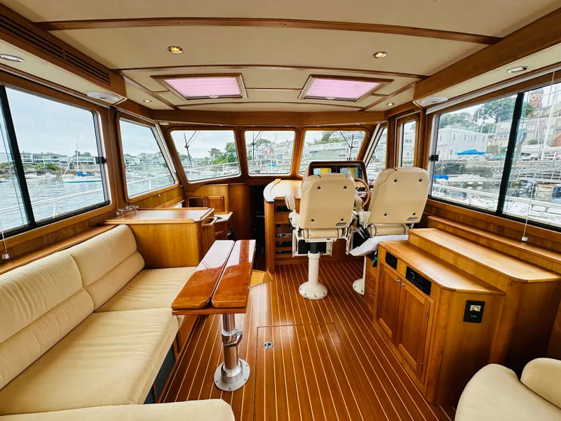 Slide: The Image of Interior of a 2011 Sabre 40 Sedan yacht with luxurious seating and wooden finishes. - 16