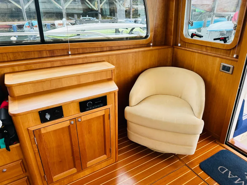 Slide: The Image of Interior of 2011 Sabre 40 Sedan with wooden cabinetry and beige chair. - 18