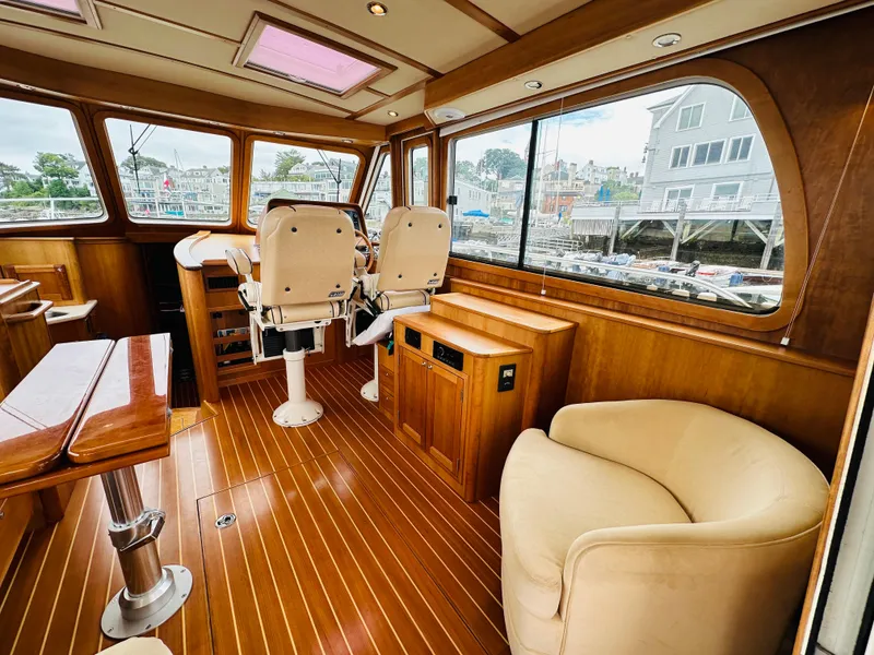 Slide: The Image of 2011 Sabre 40 Sedan interior with wooden flooring and comfortable seating. - 20