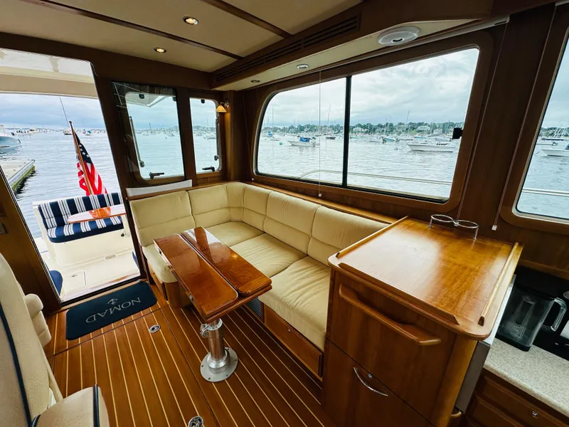 Slide: The Image of Interior of 2011 Sabre 40 Sedan yacht with wooden furnishings and marina view. - 21