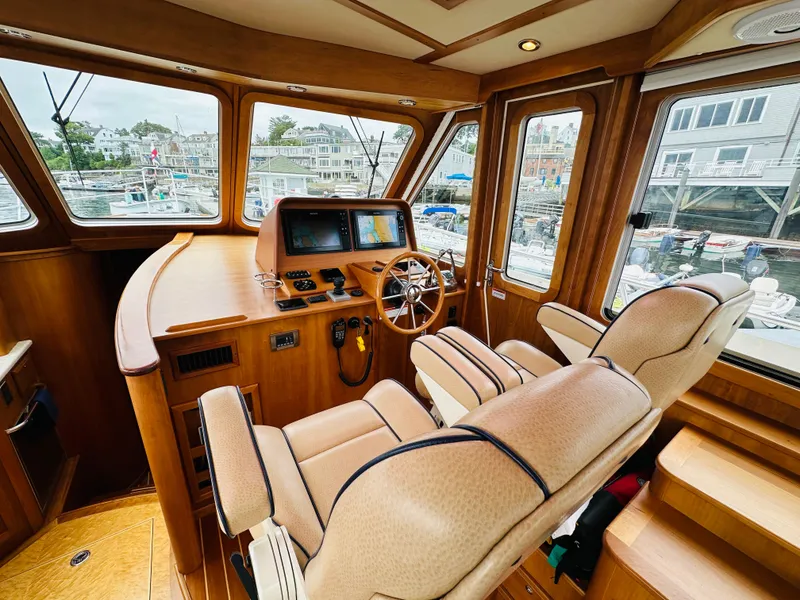 Slide: The Image of Interior of 2011 Sabre 40 Sedan yacht with helm and plush seating. - 23