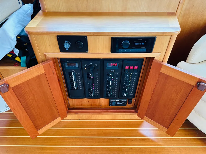 Slide: The Image of Electrical panel inside 2011 Sabre 40 Sedan yacht with wooden cabinetry. - 24