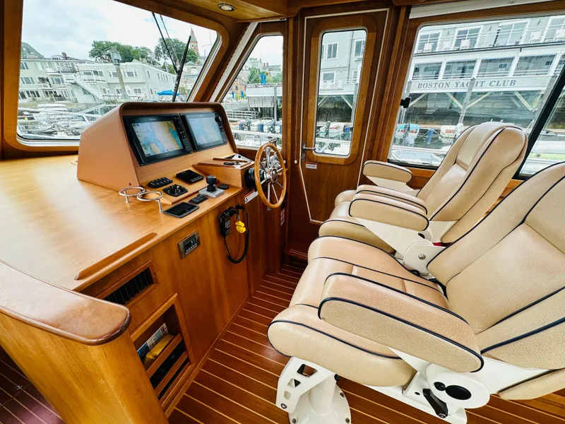 Slide: The Image of Interior of 2011 Sabre 40 Sedan yacht with luxurious seating and navigation controls. - 27
