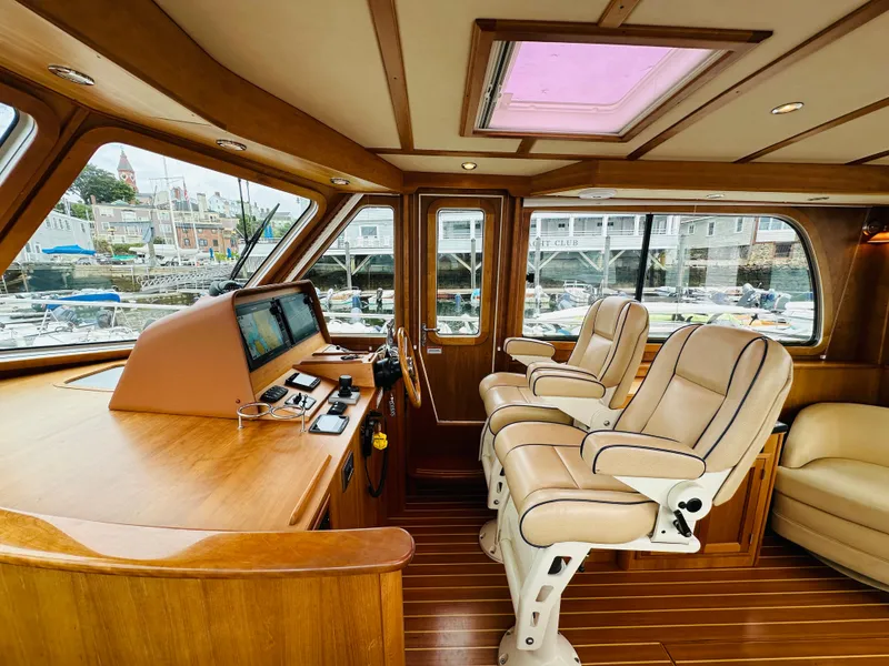 Slide: The Image of Interior of 2011 Sabre 40 Sedan yacht with luxurious seating and navigation controls. - 28