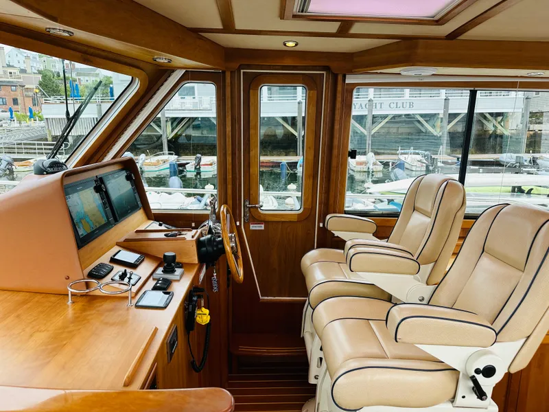 Slide: The Image of Interior of 2011 Sabre 40 Sedan yacht with leather seats and navigation equipment. - 29