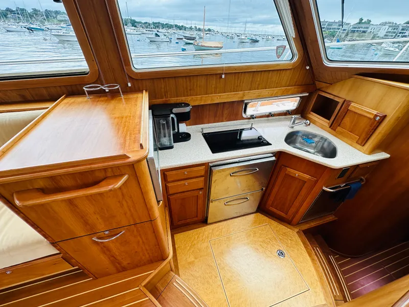 Slide: The Image of Interior of 2011 Sabre 40 Sedan yacht kitchen with wooden cabinetry and appliances. - 36
