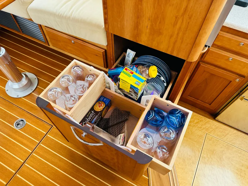 Slide: The Image of Storage drawer with glasses and snacks in a 2011 Sabre 40 Sedan yacht interior. - 38