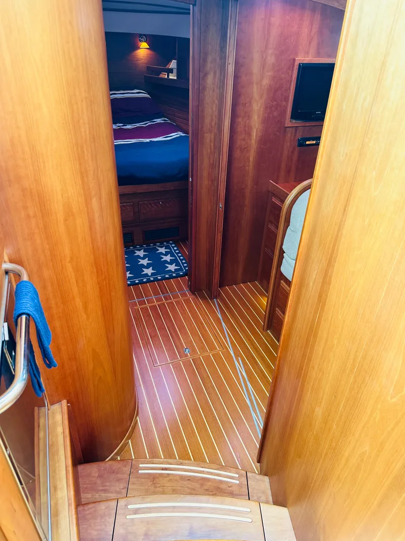 Slide: The Image of Interior of 2011 Sabre 40 Sedan yacht with wooden flooring and cozy bedroom. - 45
