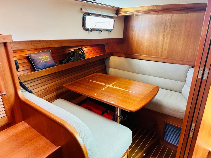 Slide: The Image of 2011 Sabre 40 Sedan interior with wooden table and cushioned seating. - 47
