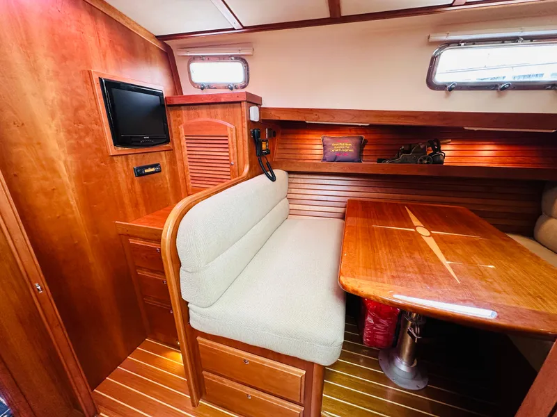 Slide: The Image of Interior of 2011 Sabre 40 Sedan yacht with wooden dining area and seating. - 48