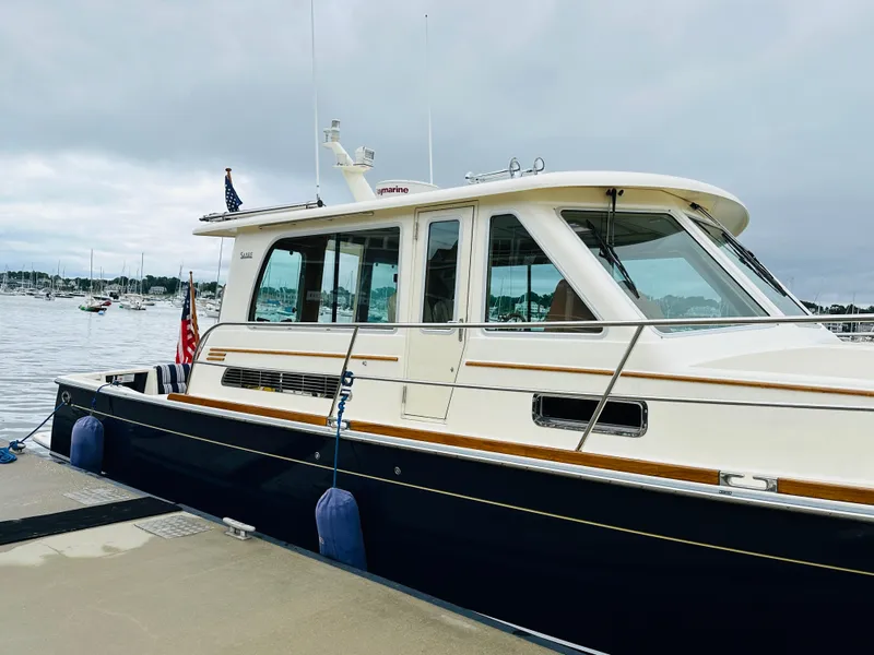 Slide: The Image of 2011 Sabre 40 Sedan yacht docked at marina, overcast sky. - 6