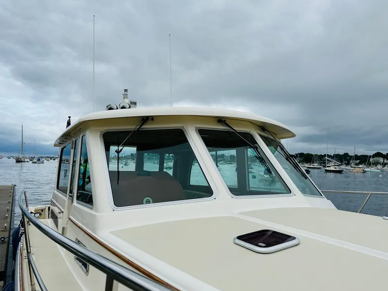 Slide: The Image of 2011 Sabre 40 Sedan boat docked at a marina under cloudy skies. - 7