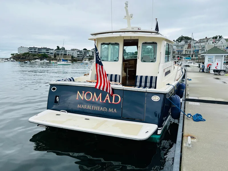 Slide: The Image of 2011 Sabre 40 Sedan docked in Marblehead, MA, with American flag. - 9