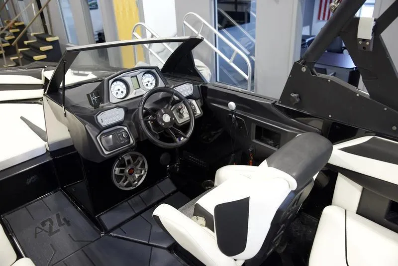 Slide: The Image of 2020 Axis A24 boat interior with modern dashboard and steering wheel. - 11