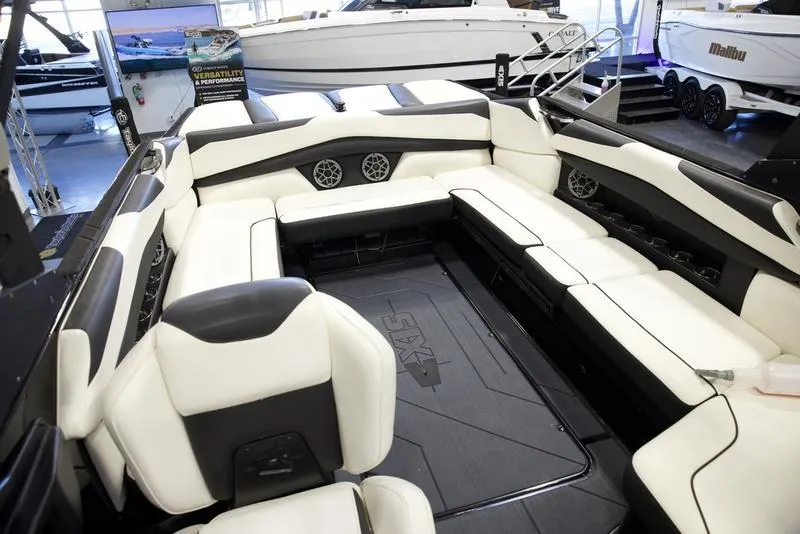 Slide: The Image of 2020 Axis A24 boat interior with white and black seating in showroom. - 15