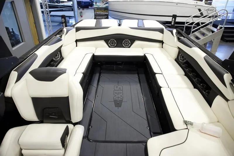 Slide: The Image of 2020 Axis A24 boat interior with white and black seating, spacious layout, and modern design. - 16