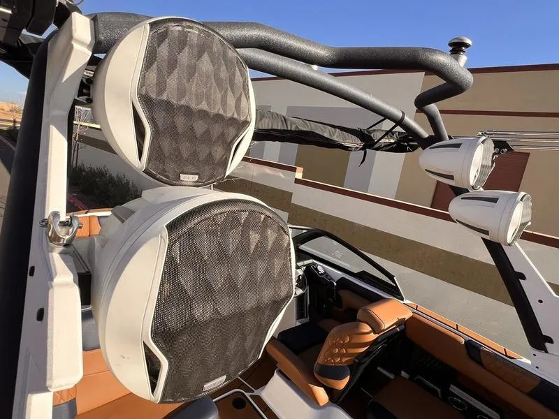 Slide: The Image of 2023 Malibu M220 boat with premium speakers and stylish interior design. - 11