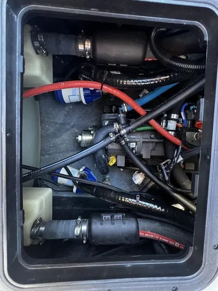 Slide: The Image of 2023 Malibu M220 engine compartment with visible hoses and wiring. - 23