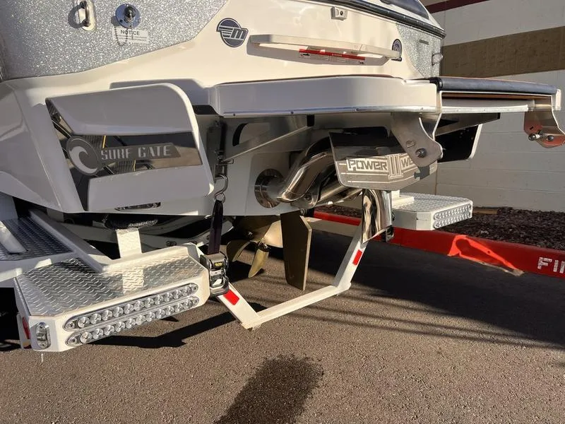 Slide: The Image of 2023 Malibu M220 boat rear view with surf gate and power wedge features. - 4