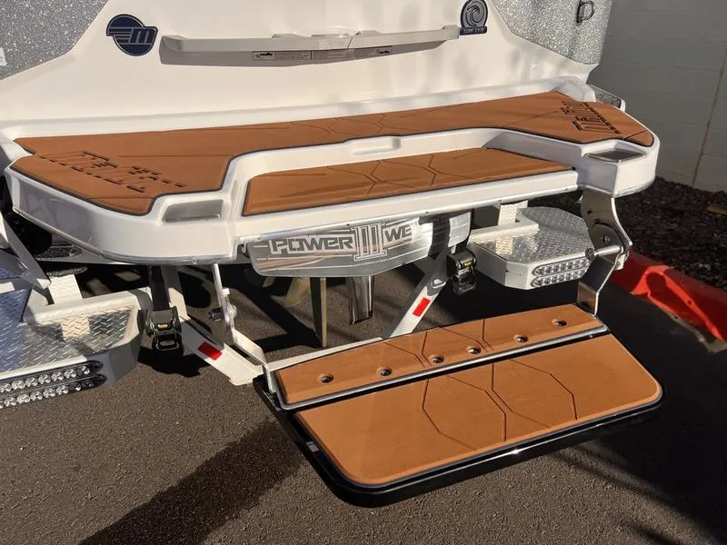 Slide: The Image of 2023 Malibu M220 boat with Power Wedge III, featuring a sleek swim platform. - 5