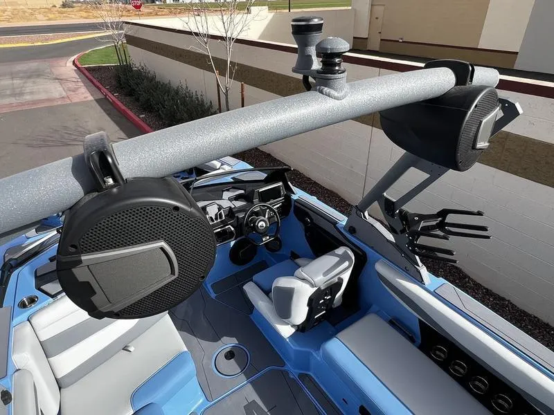 Slide: The Image of 2025 Axis A225 boat interior with speakers and seating, showcasing modern design and technology. - 11