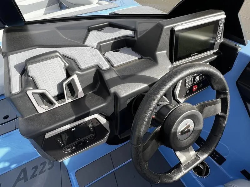 Slide: The Image of 2025 Axis A225 boat dashboard with modern controls and steering wheel. - 13