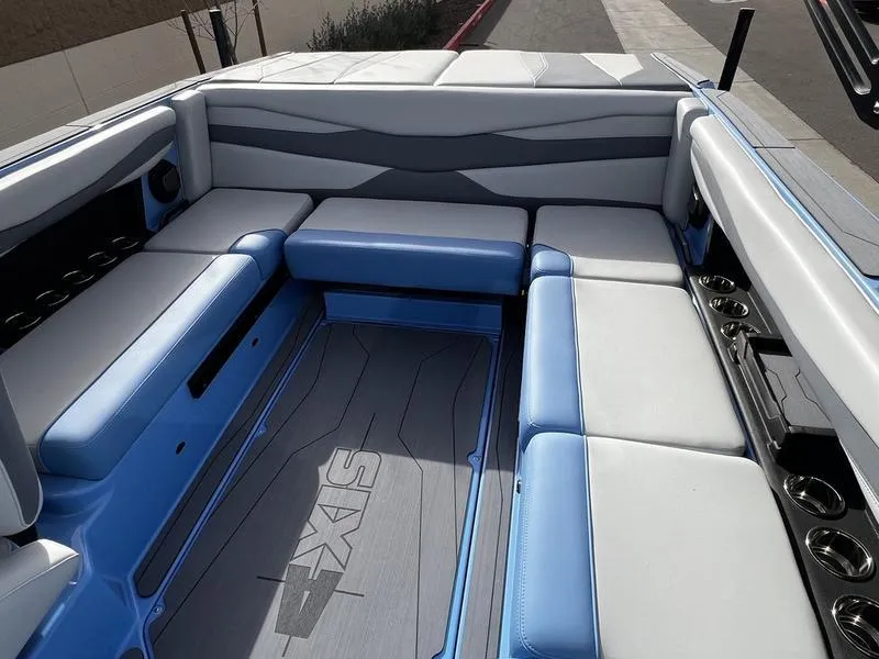 Slide: The Image of Interior of 2025 Axis A225 boat with blue and white seating. - 16