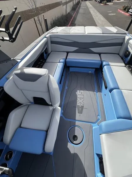 Slide: The Image of 2025 Axis A225 boat interior with blue and gray seating, showcasing modern design and comfort. - 17