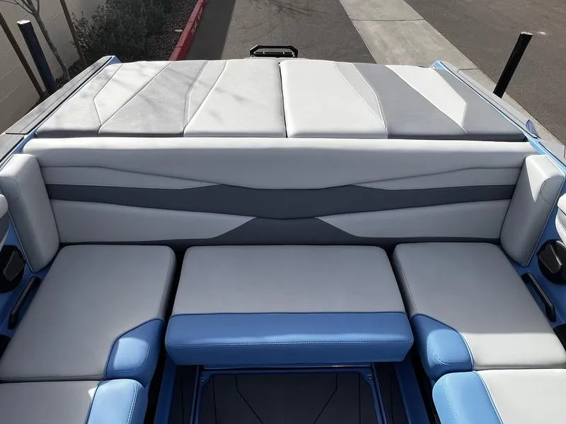 Slide: The Image of 2025 Axis A225 boat interior with blue and gray seating, modern design. - 18